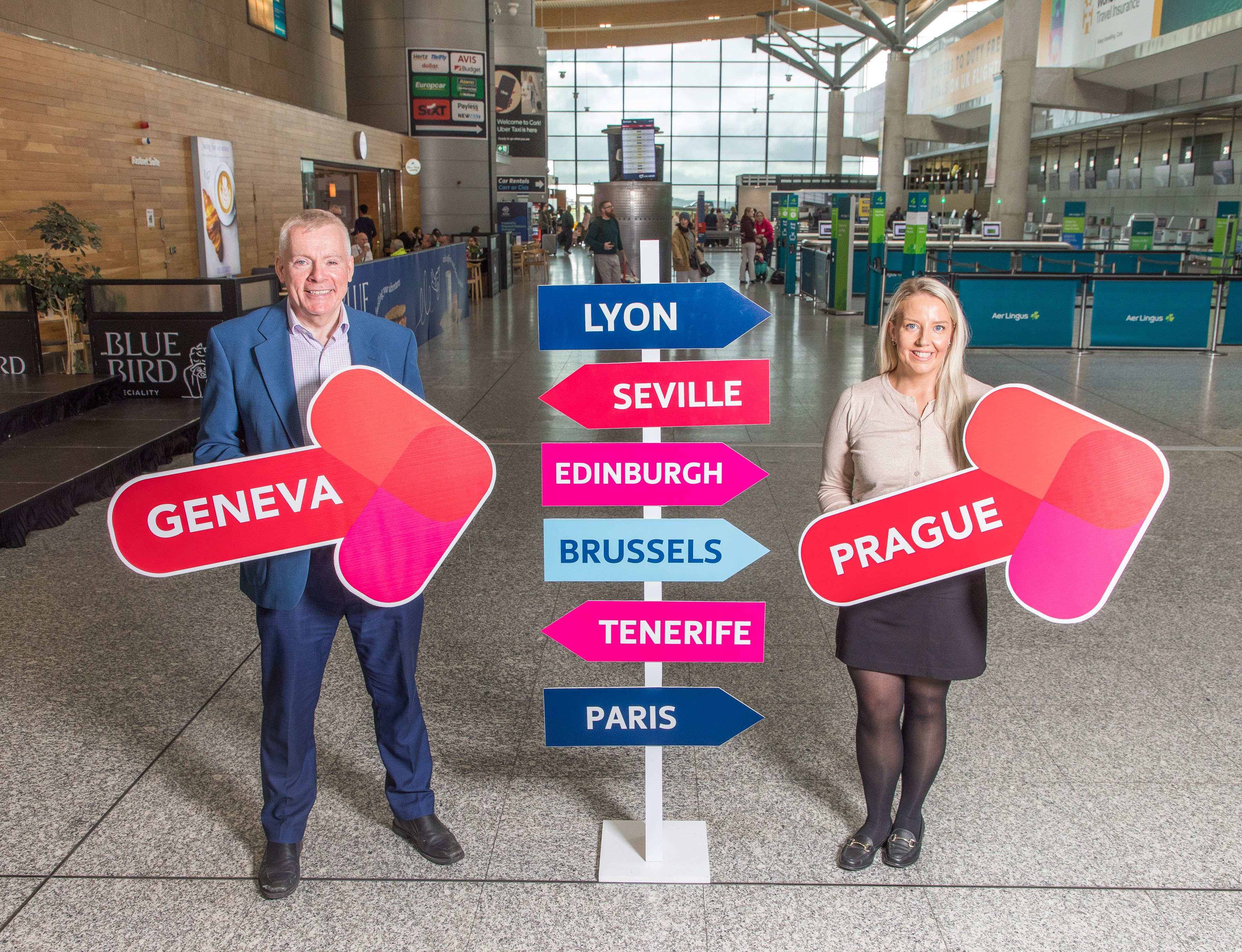 Peopla at Cork Airport holding signs